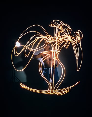 Pablo Picasso creating light drawing of vaseof flowers, Vallauris, France, 1949, Gjon Mili