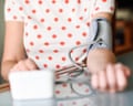 Woman measuring her own blood pressure at home.