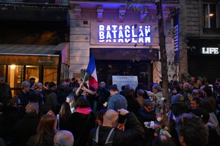 People gather outside the Bataclan concert hall at night