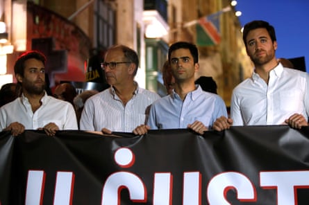 On the second anniversary of the assassination of Maltese journalist Daphne Caruana Galizia, her sons Matthew, Paul and Andrew and husband Peter take part in a protest march in Valletta, Malta October 16, 2019, carrying a banner that reads “Truth and justice”