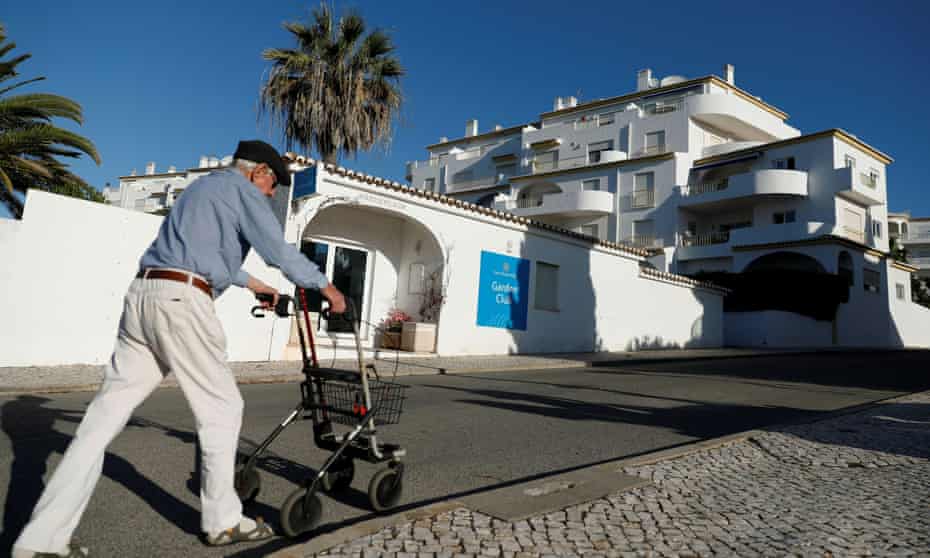 A man walks next to the apartment in Praia da Luz where Madeleine McCann disappeared in 2007
