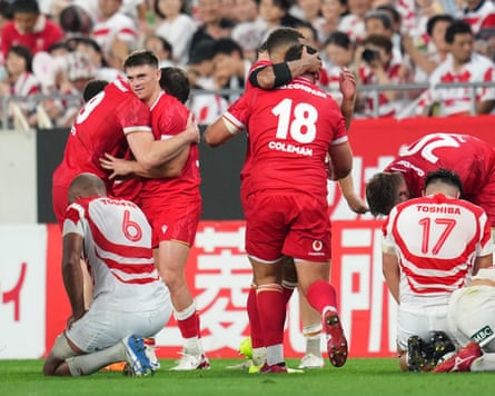Wales players celebrate victory in in Kobe.