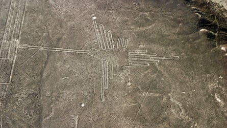 Nazca lines in the Peruvian desert showing a geoglyph representing a hummingbird.