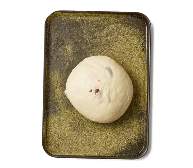 Dust a baking sheet with semolina, and, once it has risen, pop the dough ball on it.