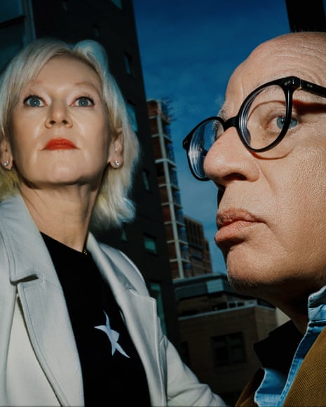 A man and a woman look up into the air