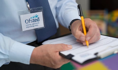 A man dressed in a shirt and tie with an Ofsted lanyard
