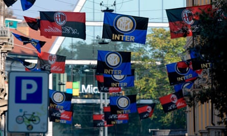 Inter and Milan flags fly in the city on derby day.