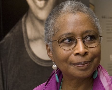 FILE - In this April 23, 2009 file photo, Alice Walker stands in front of a picture of herself from 1974 as she tours her archives at Emory University, in Atlanta. Walker and The New York Times are drawing fire after she praised an author who critics say is a conspiracy theorist who expresses anti-Semitism. In an interview in Sunday’s “By The Book” column, the author of “The Color Purple” said David Icke’s 1995 book, “And The Truth Shall Set You Free,” is on her nightstand. A New York Times spokesperson says the column is not a list of recommendations from its editors. (AP Photo/John Amis, File)