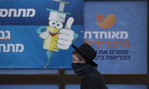 A Jewish boy walks past a coronavirus vaccination centre, in Jerusalem, as Israel becomes the first country to approve a fourth vaccine shot for vulnerable and immunocompromised people.