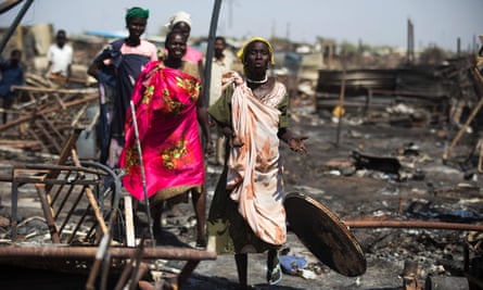 Women search for their belongings after the protection of civilians site in Malakal was burnt and looted