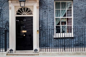 A member of staff sticks a poster of a rainbow on a window at 10 Downing Street last April, while Boris Johns is in hospital with coronavirus