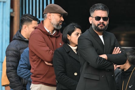Balendra Shah lines up outside a polling station to vote.