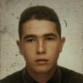 A grainy headshot of Jean Charles de Menezes.
