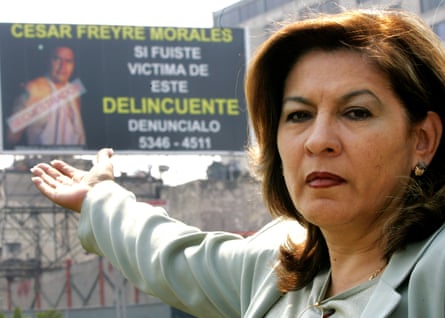 Isabel Miranda de Wallace points to a billboard she had installed on a street in Mexico City asking for victims of Cesar Freyre to get in contact.