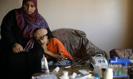 Mohammad Shanty, who suffers from cystic fibrosis, sits next to his mother