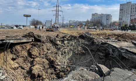 A crater is left after a Russian missile attack on the Shevchenkivskyi district in Kharkiv, where eight people died, officials said.