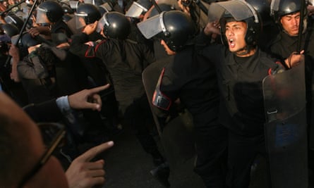 Egyptian riot police confront protesters during a demonstration in Cairo on 25 January 2011.