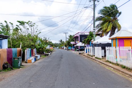 A street of colourfully painted houses and palm trees