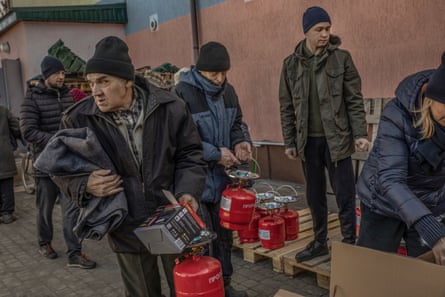 People carry aid from a distribution point