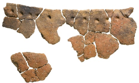Fragments of a large early Neolithic bag-shaped round-bottomed vessel with finger impressions spaced below the rim.