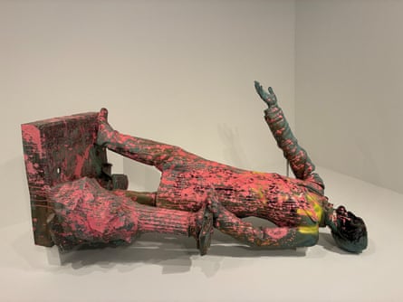Toppled statue of Jefferson Davis spattered with neon pink paint.