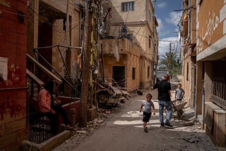 People clean up debris in a street in Lebanon