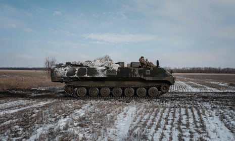 A Ukrainian armoured personnel carrier runs in the field near Bakhmut.
