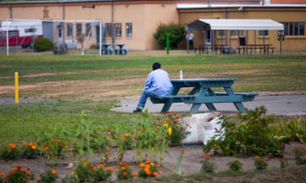 A resident sits on a bench. Civil confinement in Washington cost $185,136 per resident in 2018.