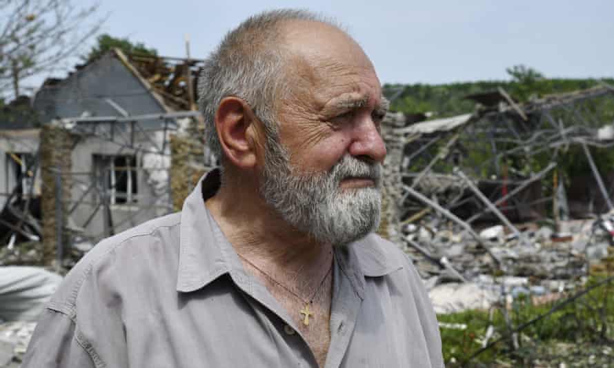 A man stands next to a building damaged by an overnight missile strike in Sloviansk, Ukraine.