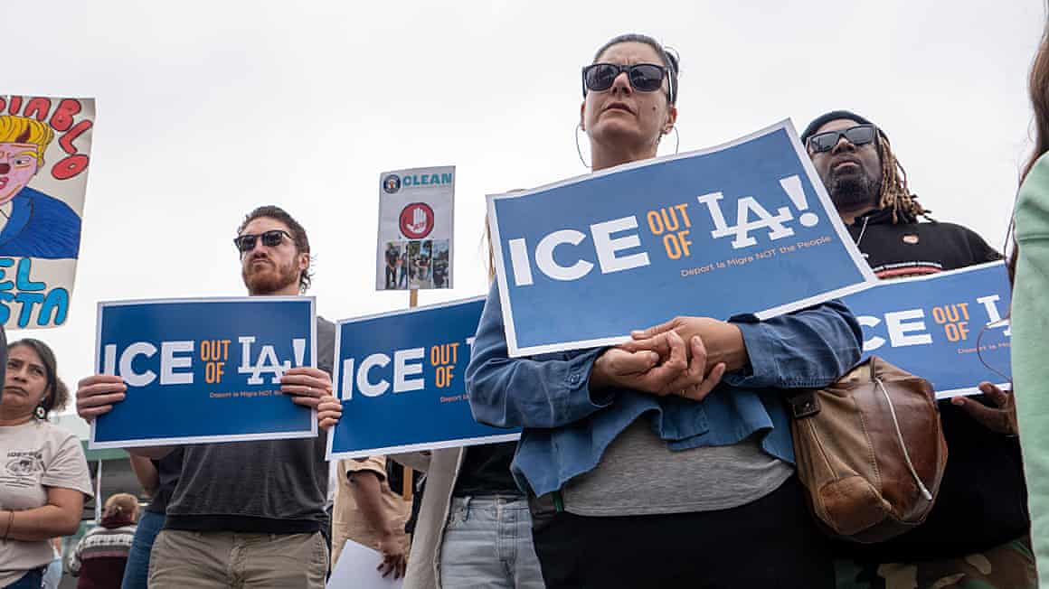 People holding 'Ice out of LA' banners