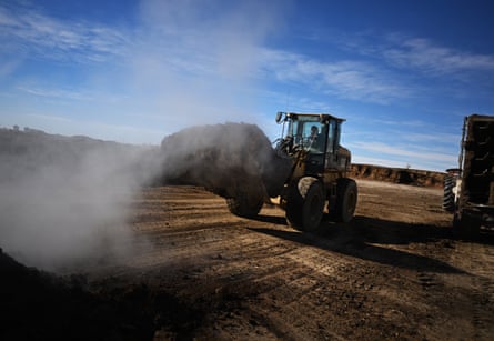 a tractor spreading fertilizer