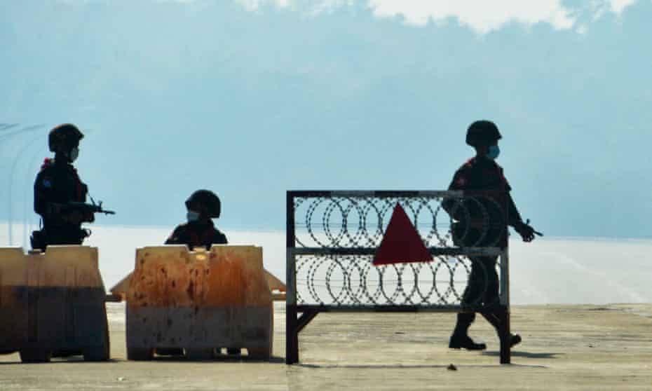 Soldiers keep watch along a blockaded road near Myanmar’s parliament in Naypyidaw