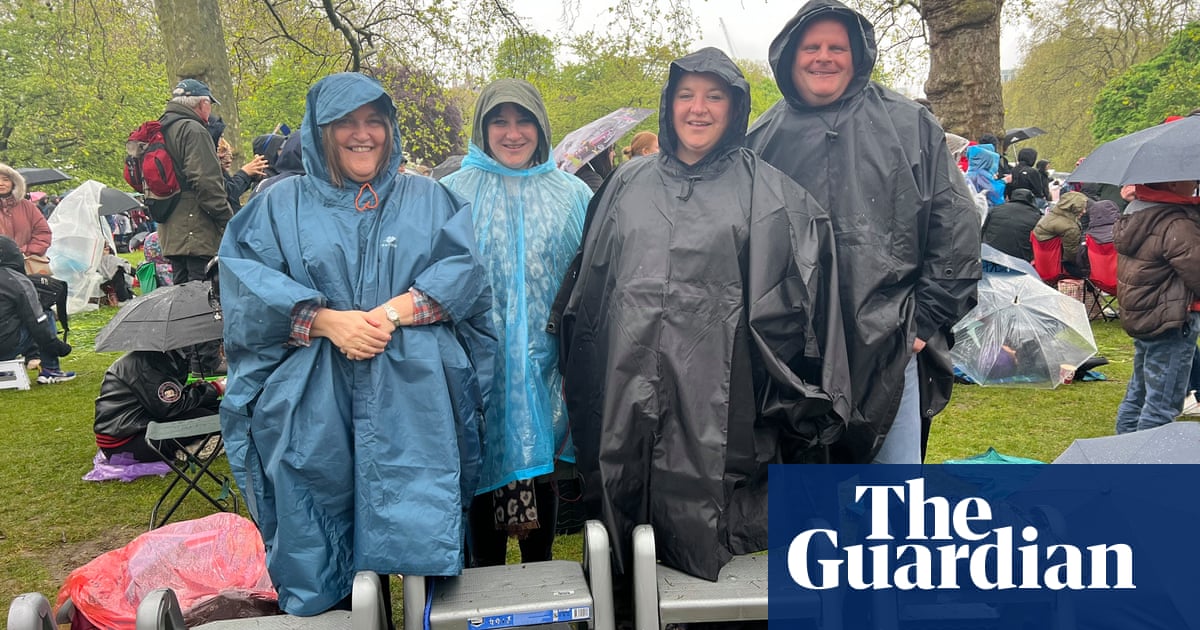 Royal fans refuse to let rain spoil coronation day - The Guardian
