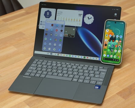 A Google Pixel 11 Pro phone leaning on an Asus Googlebook 14âÂÂs screen.