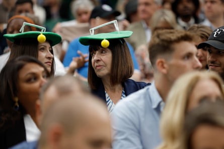 Spectators in tennis-themed hats on Centre Court.