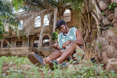 Olamilekan Adekeye sits by nan watercourse to drawback achromatic flies.