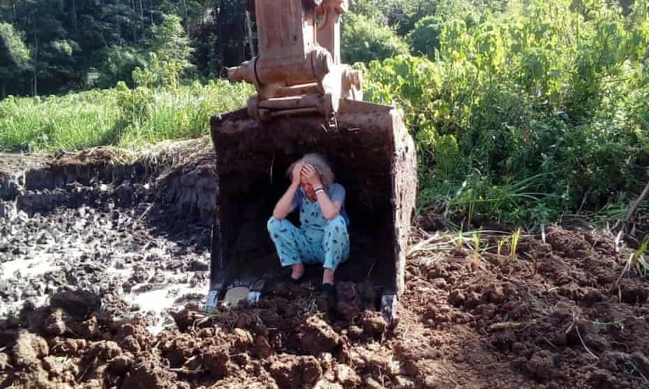 Joannah Stutchbury sitting in the scoop of a digger
