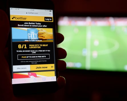 A smartphone user accesses the Betfair gambling website