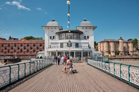 View down Penarth’s wooden-decked pier towards an art deco pavilion and other large buildings behind
