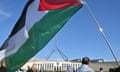 Supporters hold flags at a pro-Palestine rally outside Parliament House in Canberra