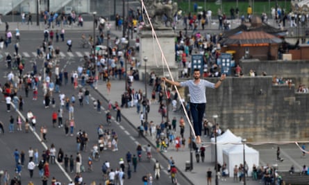 Nathan Paulin traverses a slackline between the Eiffel Tower and the Chaillot theatre in Paris, France