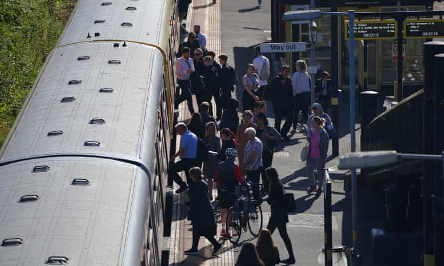 Passengers board a train at Hunts Cross Station, Liverpool.