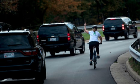 Juli Briskman giving the middle finger to Trump’s motorcade while riding a bike in 2017.