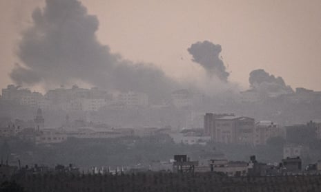 Debris in the air after Israeli airstrikes on Gaza City, as seen from the border area on Saturday near Sderot, Israel\