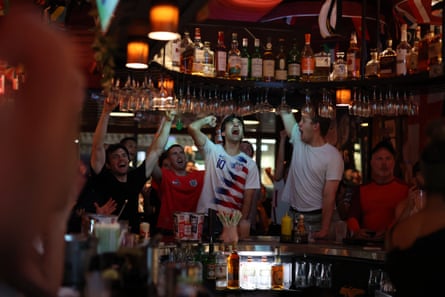 people cheering in a bar