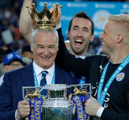 Claudio Ranieri and Kasper Schmeichel with Christian Fuchs behind and the Premier League trophy in 2016