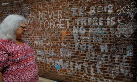 Susan Bro, mother of Heather Heyer, looks at the memorial and writings at the site where her daughter was killed in Charlottesville.