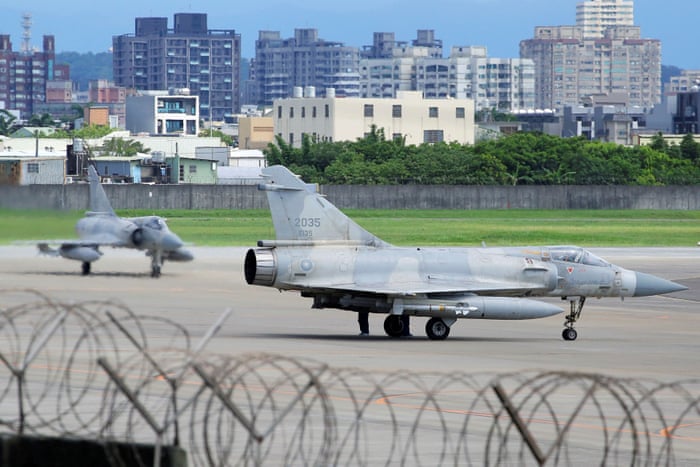 A Taiwan Air Force aircraft arrives next to a Mirage 2000-5 fighter jet upon landing at Hsinchu Air Base in Taiwan.
