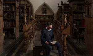 The keeper of the muniments, Matthew Payne, holding the manuscript in the Westminster Abbey library.