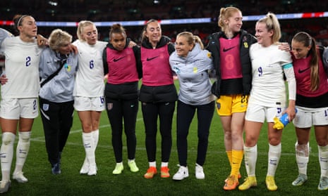 Sarina Wiegman embraces the England players after a 2-1 win against the USA